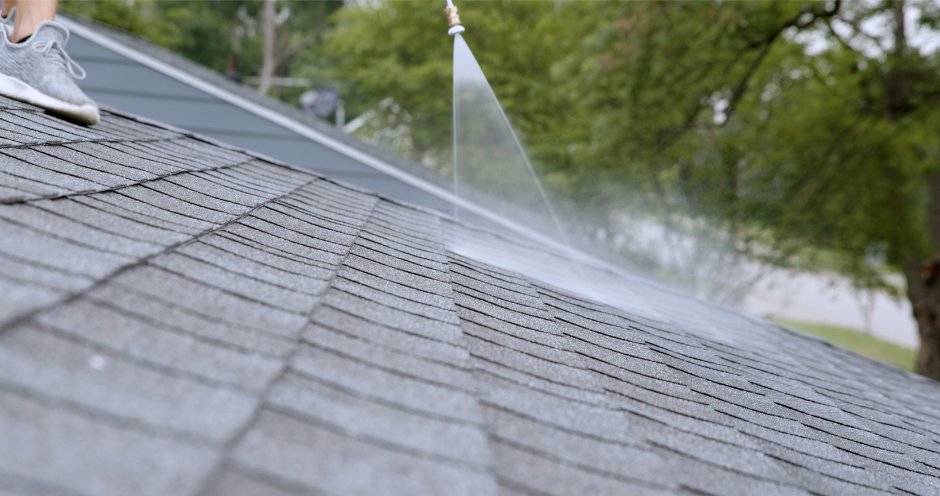 Rejuvenation treatment being sprayed across asphalt shingles
